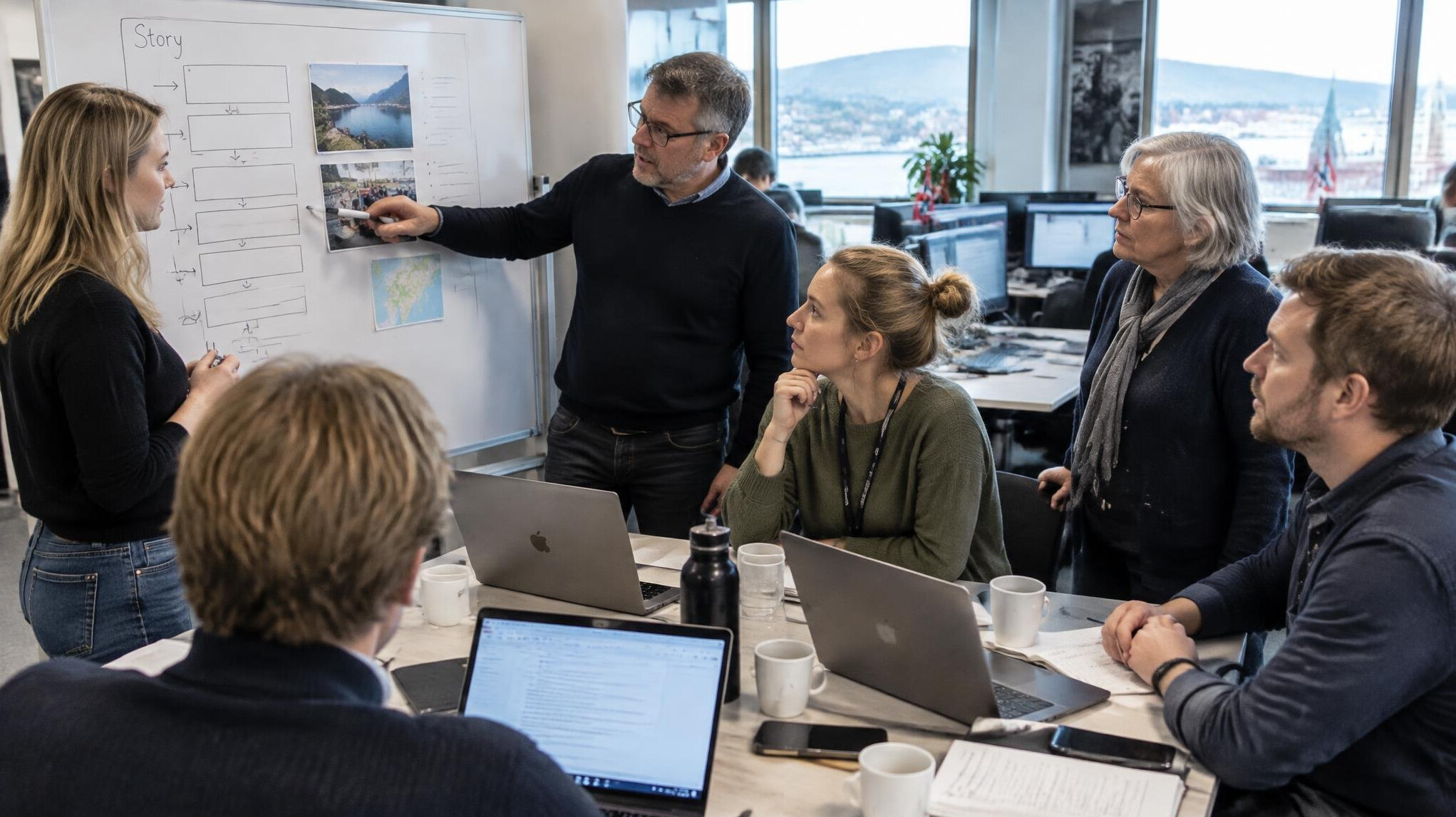 Journalists planning a news story in a modern newsroom