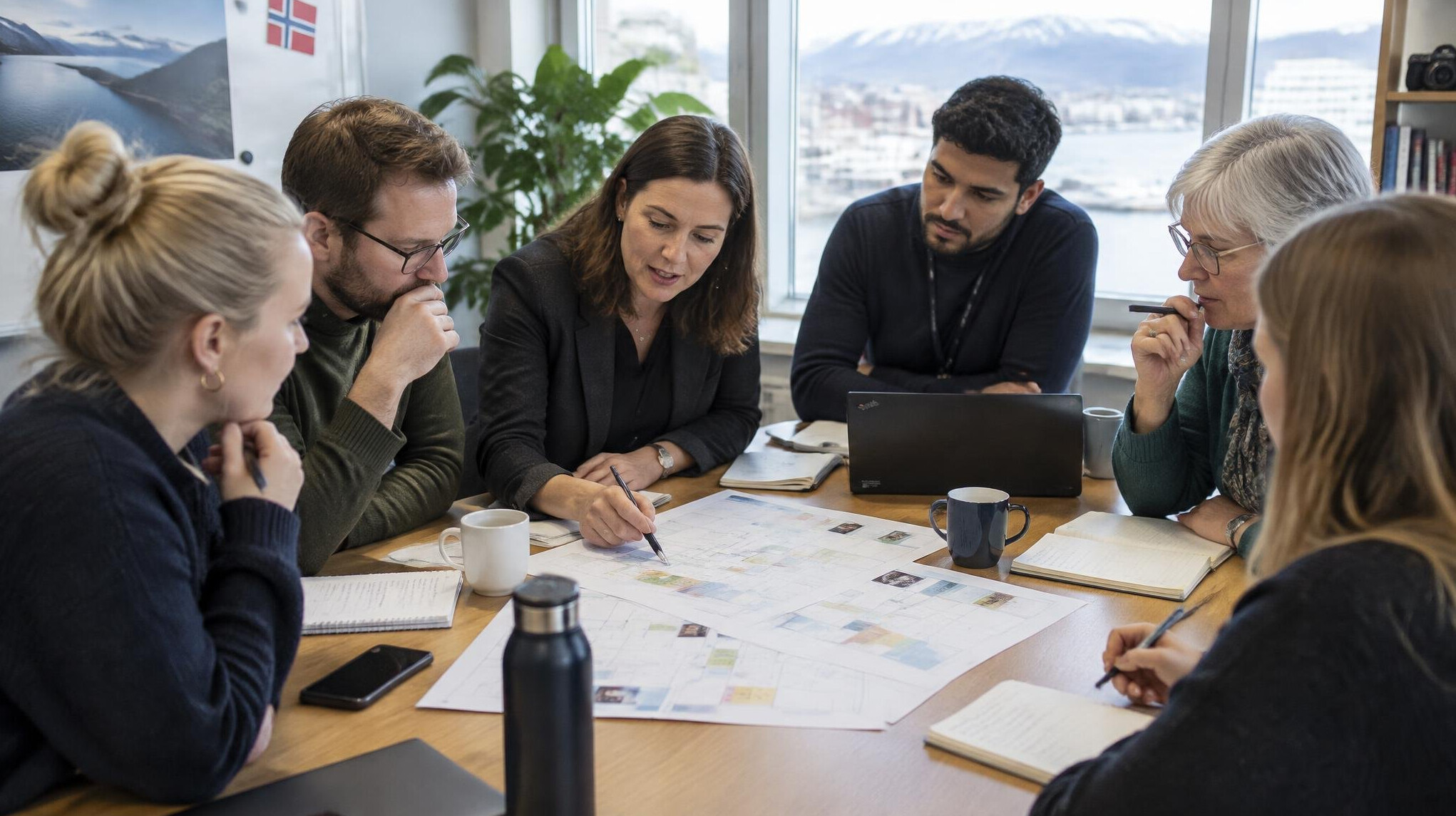 Editorial team reviewing a story planning calendar