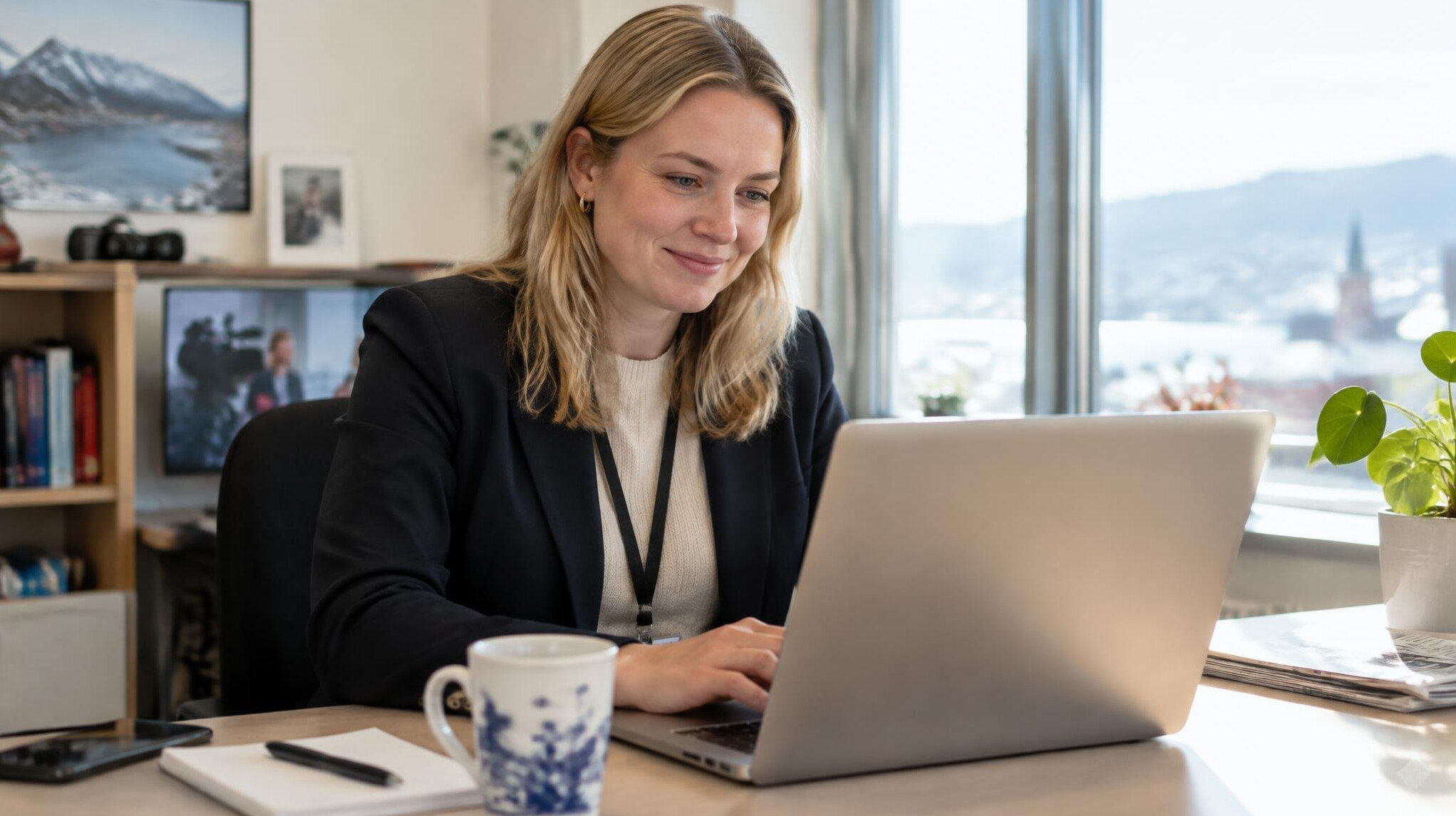 Media professional responding to messages at a desk