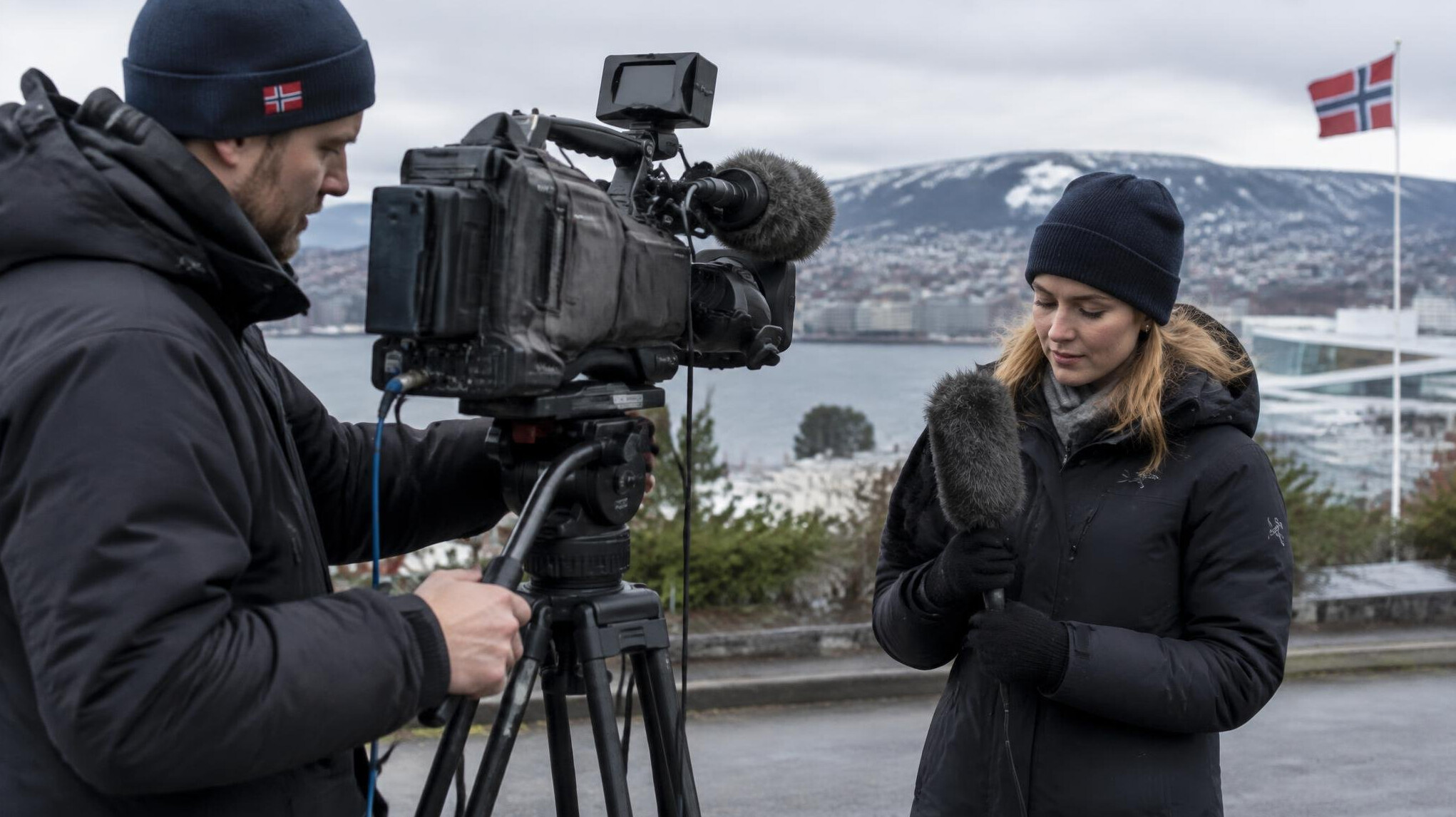 Camera operator and reporter setting up for a live broadcast
